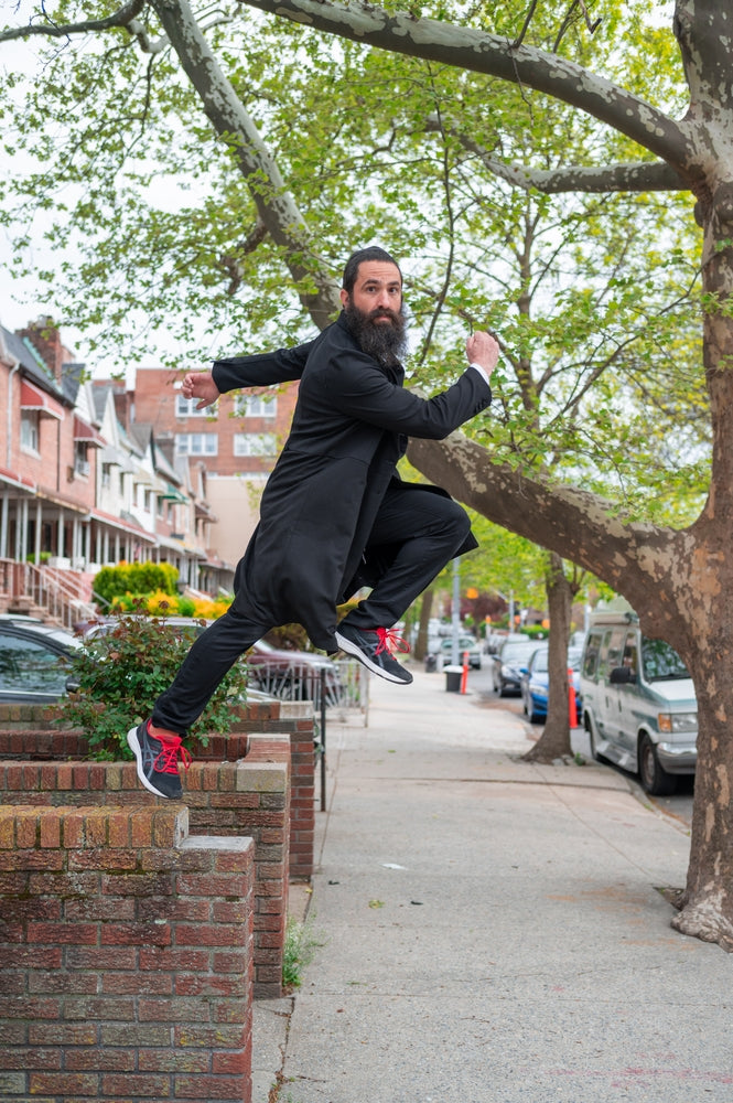 Bearded Chabad Chossid Runner Leaping Jumping in Running Shoes wearing his Stretchy Breathable Beinoni Kapota